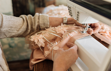 Seamstress sewing a formal dress