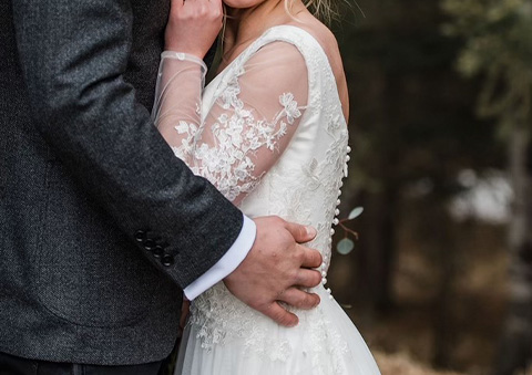 Bride with sleeve lace detail wedding dress