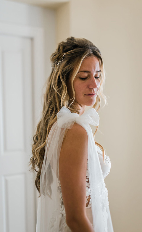 Bride with bow detail on sleeve of wedding dress